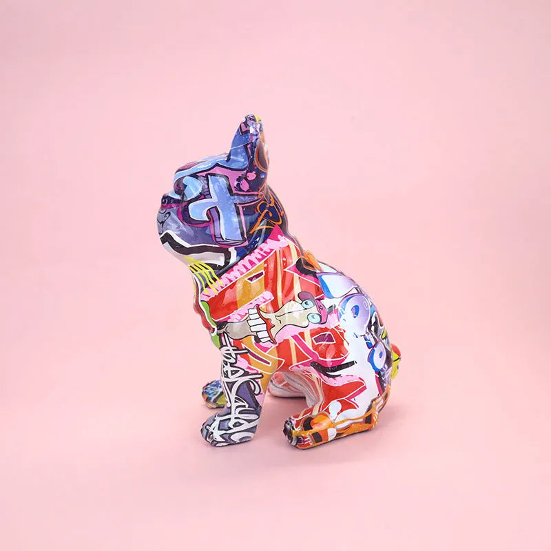 Graffiti-coloured resin French bulldog statue on a plain background.