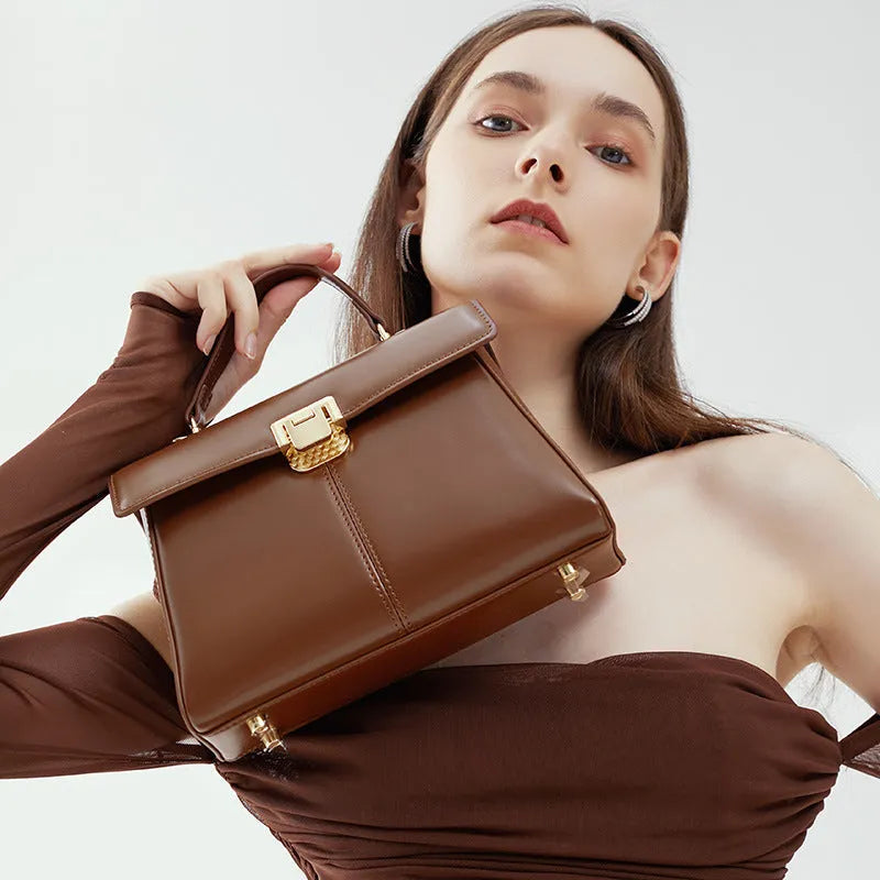Black genuine leather women's shoulder bag with Vachette clasp closure and adjustable strap