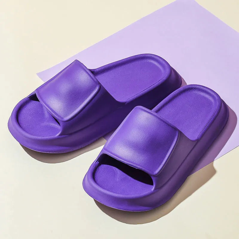 Pair of thick-soled EVA flip-flop slippers in a choice of seven colours, shown on a wet bathroom floor.