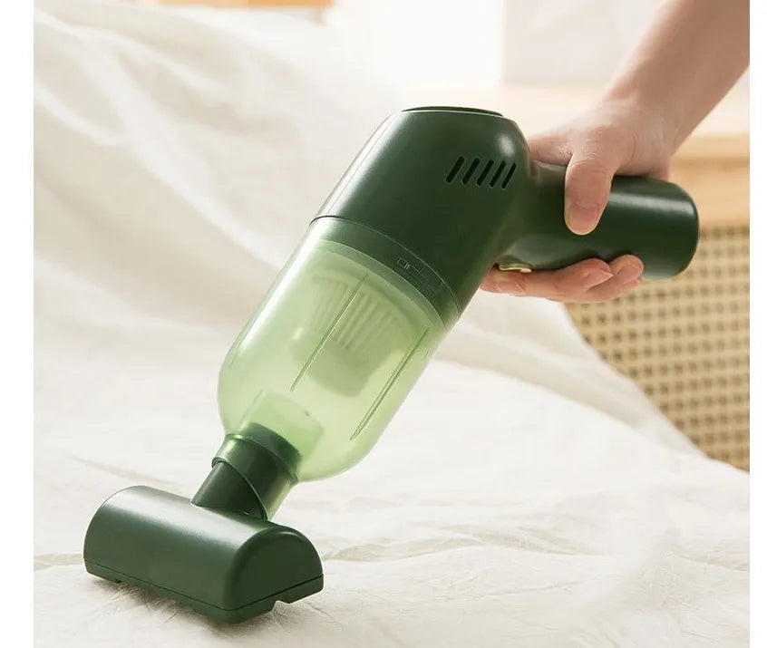 Green electric cat hair cleaner with suction heads for beds