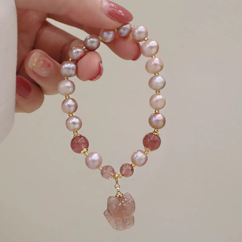 Light pink freshwater pearl bracelet for women with a dangling silver fox charm.