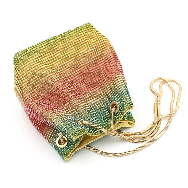 Rainbow coloured rhinestone bucket bag with an adjustable metal chain strap.