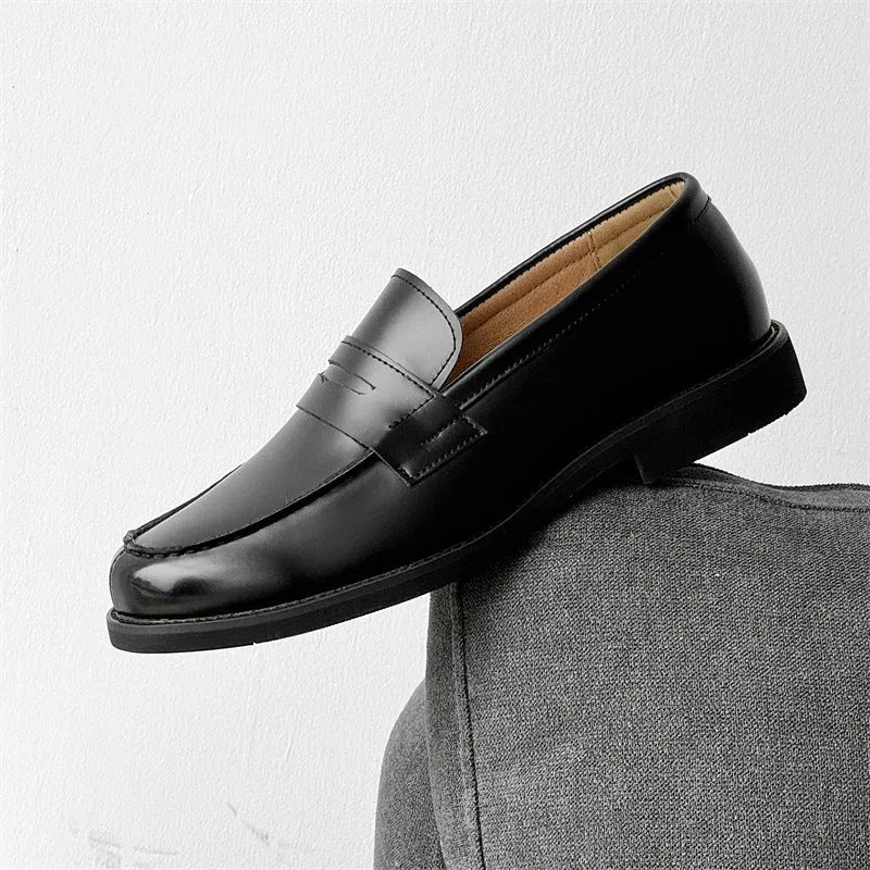 Black men's classic slip-on derby leather shoes with a rubber sole, shown in a mature style.