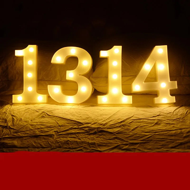Plastic LED letter light decoration spelling a message, 22cm in height.