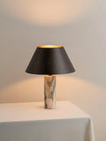 Black marble table lamp with modern simplicity design on a wooden table