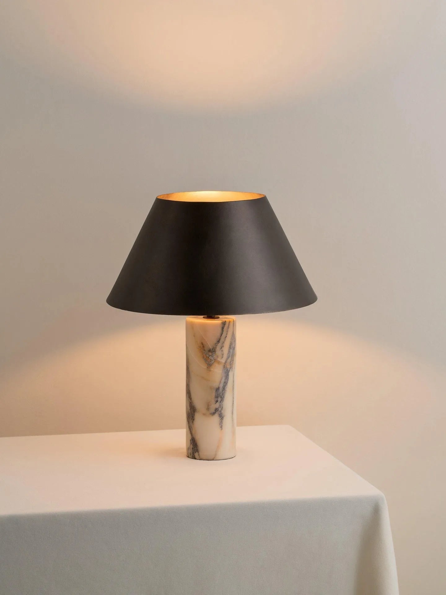 Black modern marble table lamp with LED light source on wooden surface