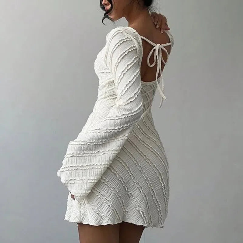 White knitted boat neck back tie dress with flared sleeves and pleated puff skirt