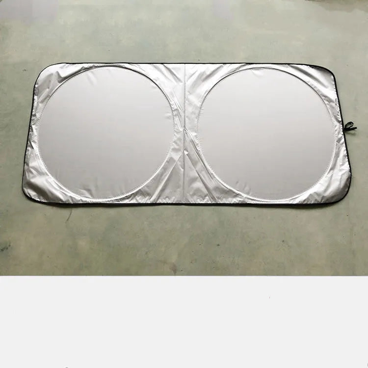 Silver tape car sunshade in 190x90cm size laid against a car windshield