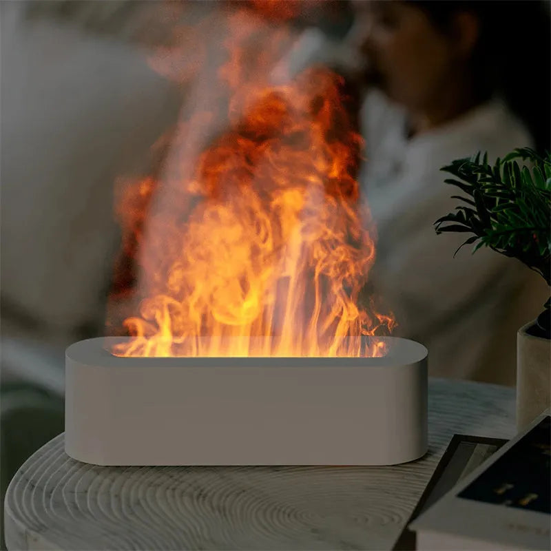 White square ultrasonic flame aroma diffuser and humidifier with LED light on a table.