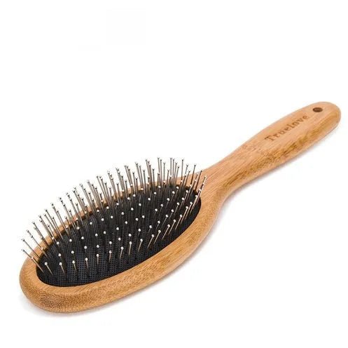 Medium pet deshedding comb with bamboo handle and stainless steel needles in original bamboo colour on a flat surface