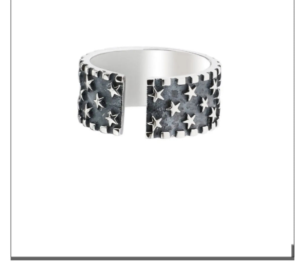 Sterling silver ring with a five-pointed star pattern and an adjustable open band.