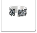 Sterling silver ring with a five-pointed star pattern and an adjustable open band.