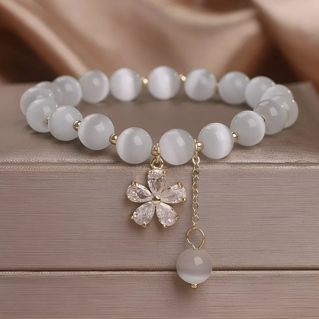 Women's white cat's eye bracelet with flower tassel and safety buckle pendant