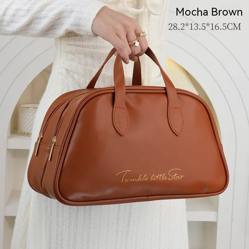 PU leather travel toiletry bag in classic black colour, showing large capacity and zipped compartments.