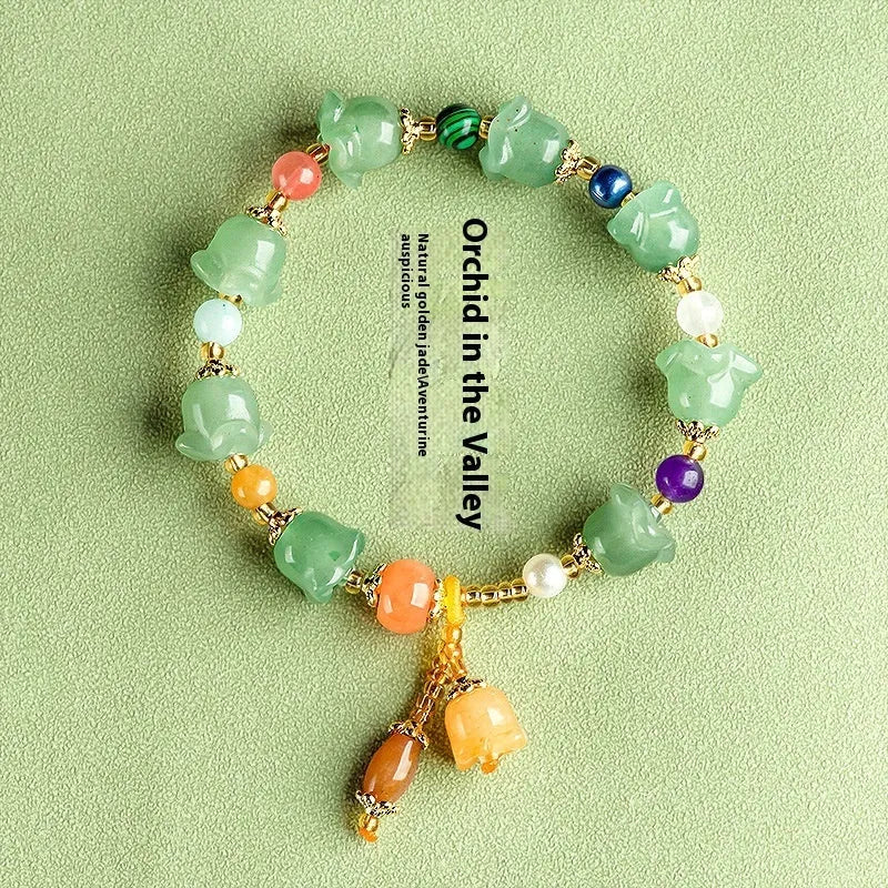 Natural Jinsi Jade bracelet with carved orchid beads on a wrist.