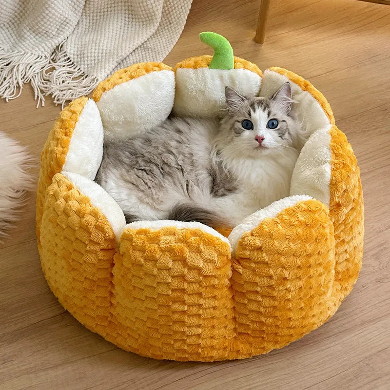 Orange pumpkin-shaped pet nest bed for cat or small dog with cotton filling.