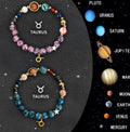 Two natural stone beaded bracelets with zodiac charms on a table.