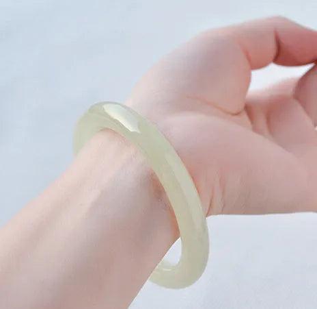 Solid ice silk jade round bar bracelet showing smooth geometric shape on a plain background