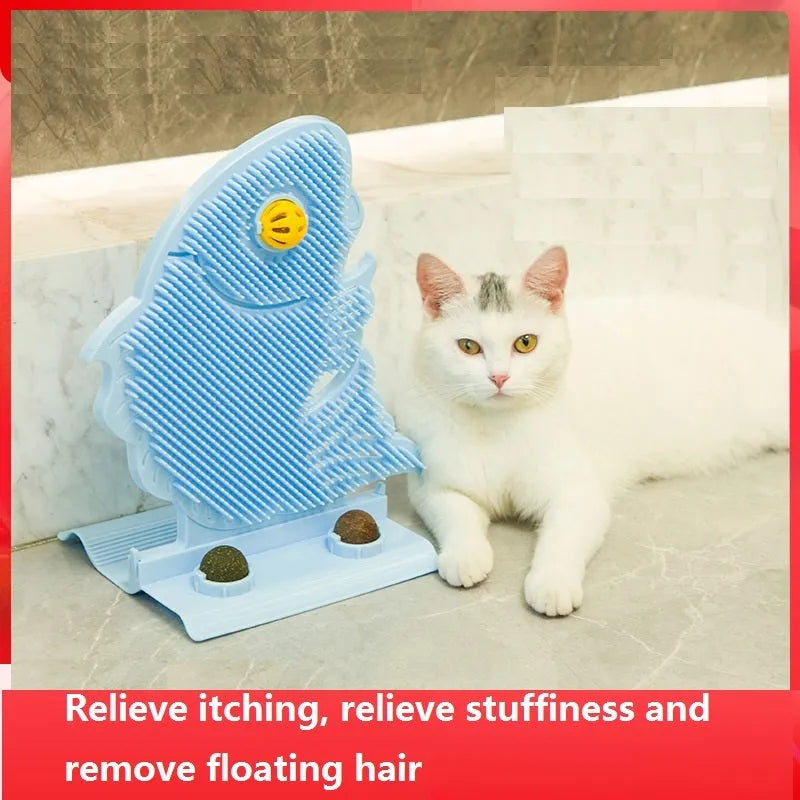 Blue plastic fish-shaped cat wall scratcher with brush, two green catnip balls, a bell, and a mounting base.