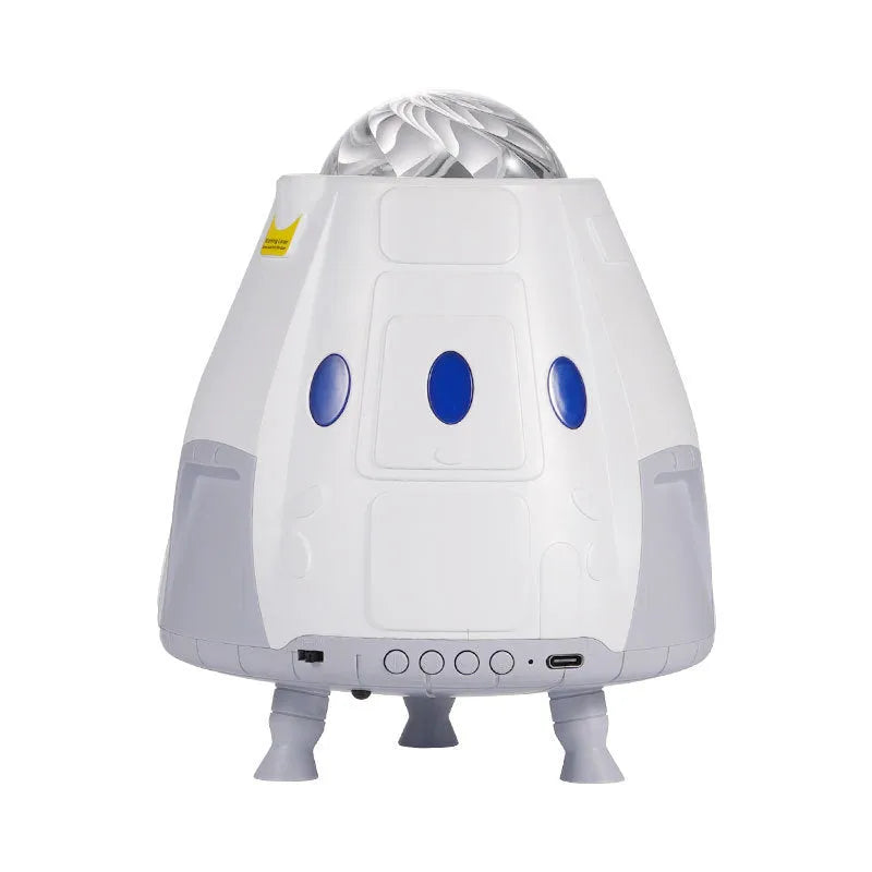 Space capsule shaped projection lamp showing galaxy lighting effects on wall, available in Space Grey or Space White finish