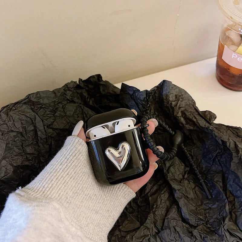 Black earphone sleeve with electroplated love heart design for AirPods case showing TPU back cover and black cord