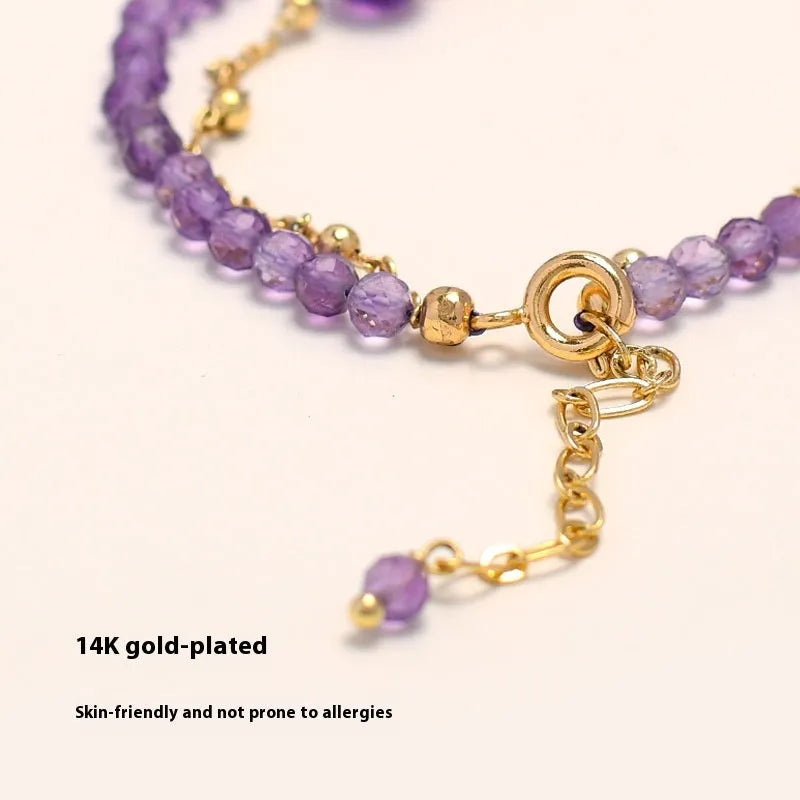 Close-up of an amethyst coloured Chinese style bracelet for women, featuring electroplated diamond-shaped crystals.