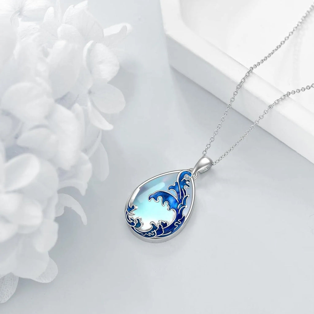 Close-up of a moonstone blue heart-shaped alloy pendant on a women's necklace.