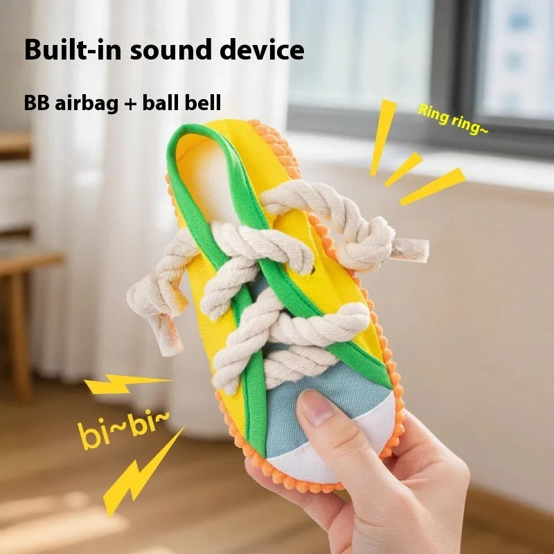 Plastic dog toy shaped like slippers in yellow, black, or blue, designed for chewing and making sound.
