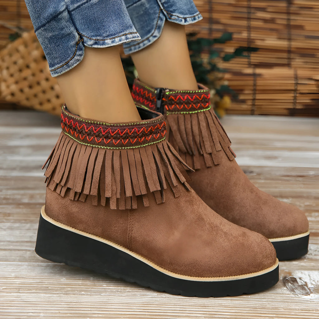 Women's suede wedge ankle boots with side zipper, thick rubber sole, and tassel detailing in dark brown colour