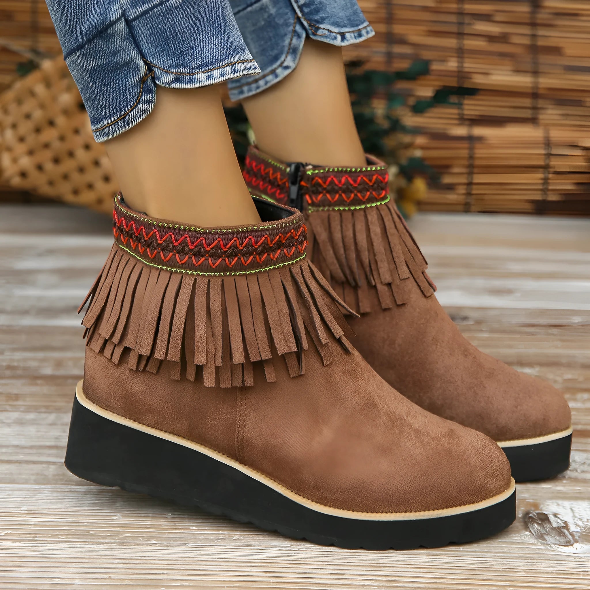 Women's suede wedge ankle boots with side zipper, thick rubber sole, and tassel detailing in dark brown colour
