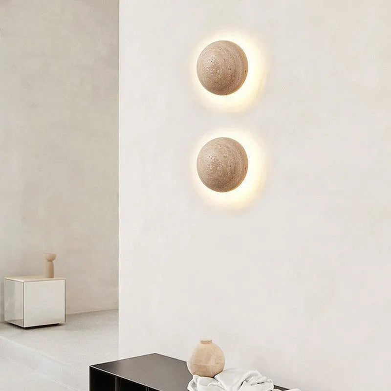 Yellow semicircle cave stone wall lamp with wooden fixture mounted on a wall.