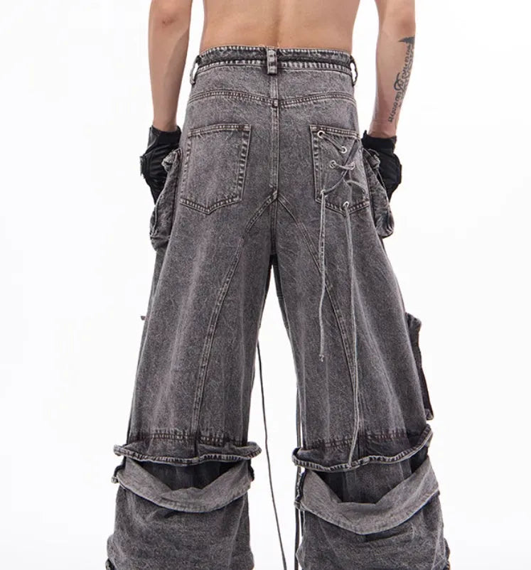 Grey distressed denim overalls with rope stitching on a hanger