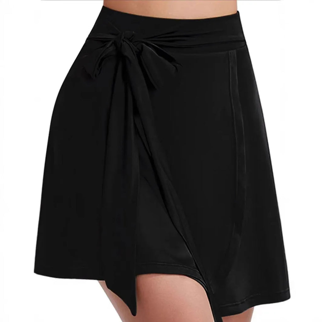 Black thigh-length sports skirt with anti-exposure shorts, high waist design, and shoulder strap detailing