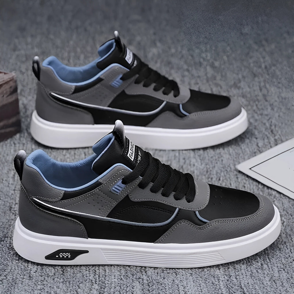 Men's low-top canvas board shoes in beige with leather stitching detail on a white background.