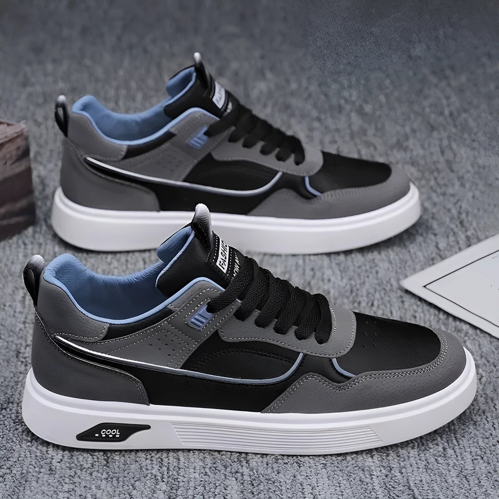 Men's low-top canvas board shoes in beige with leather stitching detail on a white background.