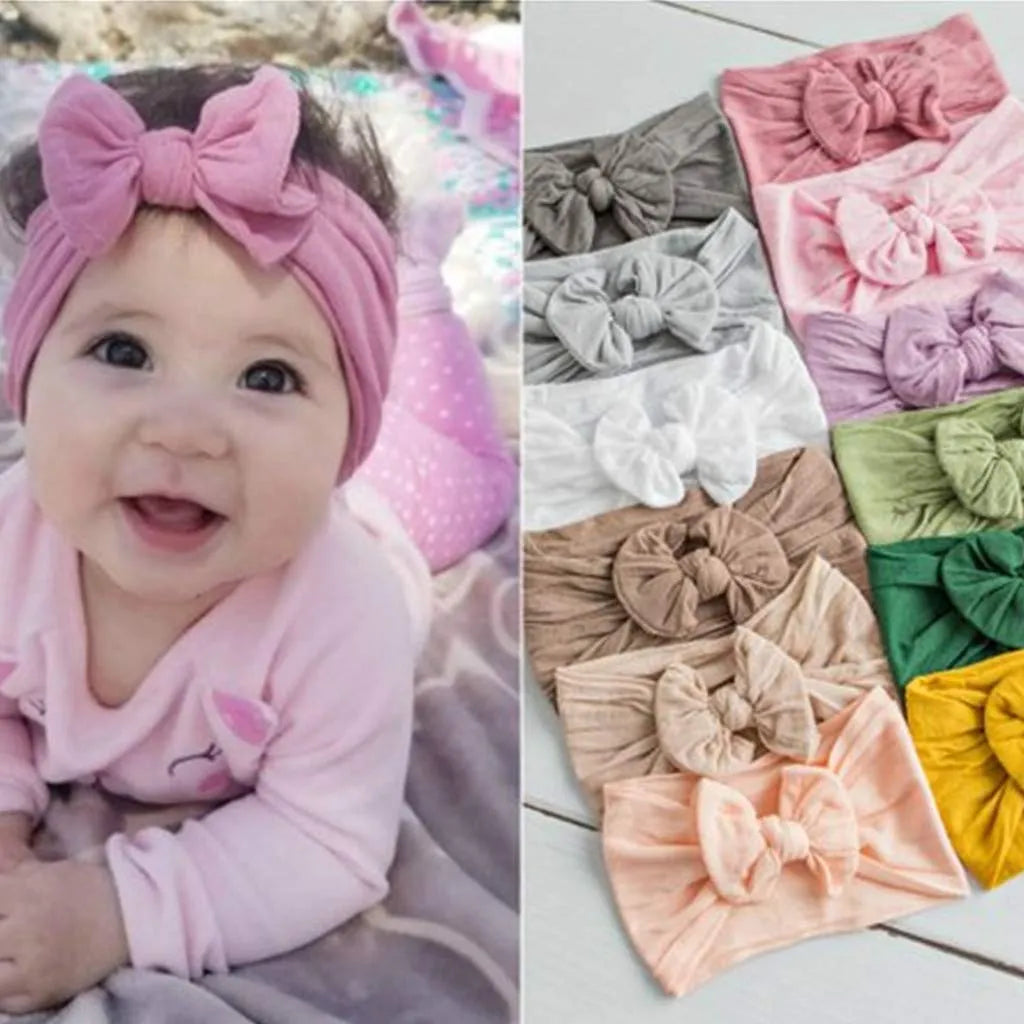 Super stretchy soft knot headband with hair bow for baby girls in one of 22 colours