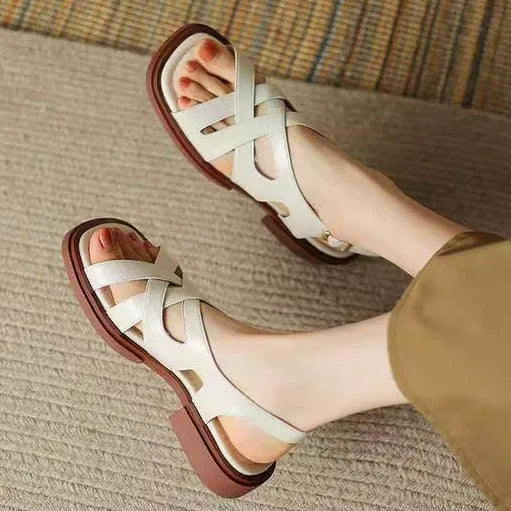 Women's glossy black patent leather beach sandals with a square toe and cross-belt design on a rubber sole.