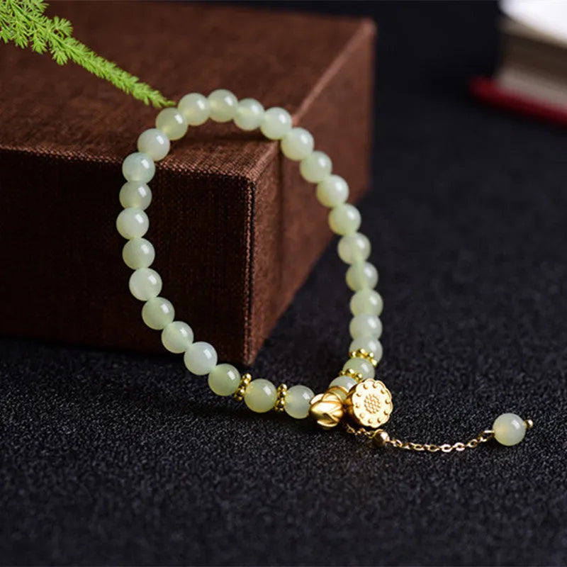 Natural Hetian Jade bracelet with six millimetre beads in step by step lotus pattern