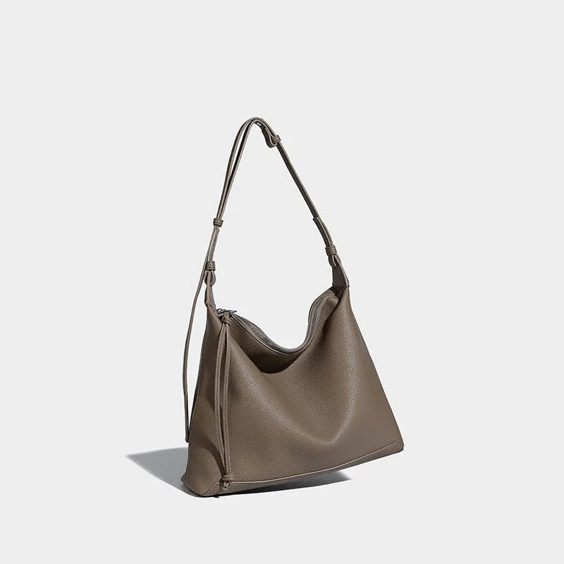 Soft PU leather messenger bag in caramel colour showing large capacity and shoulder strap.