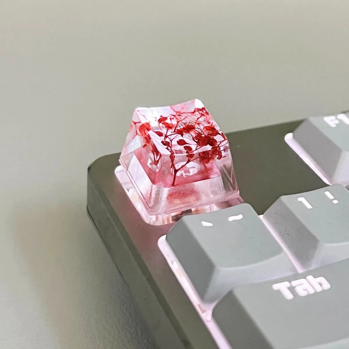 Transparent resin mechanical keyboard keycap with starry sky pattern in red, pink, green, and violet colour options