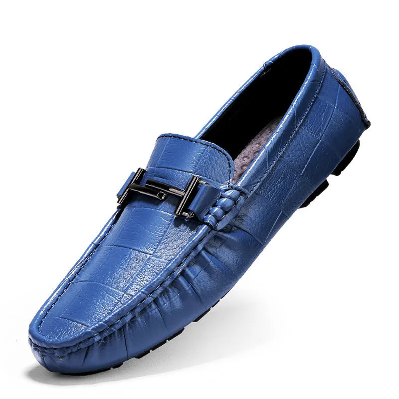 Men's black leather casual shoes with a silver belt buckle closure on a flat rubber sole.