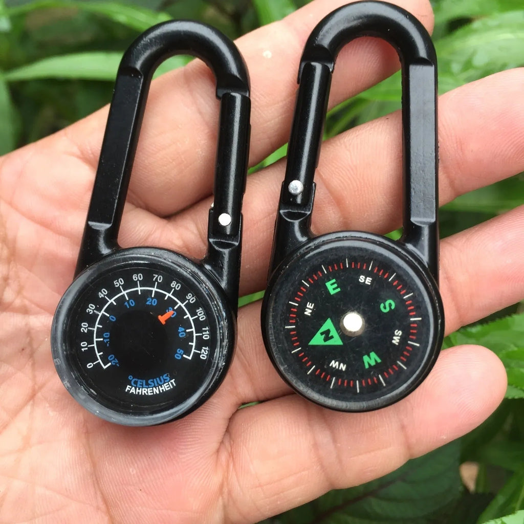 Army green zinc alloy outdoor carabiner with built-in fluid compass and liquid thermometer showing temperature scale