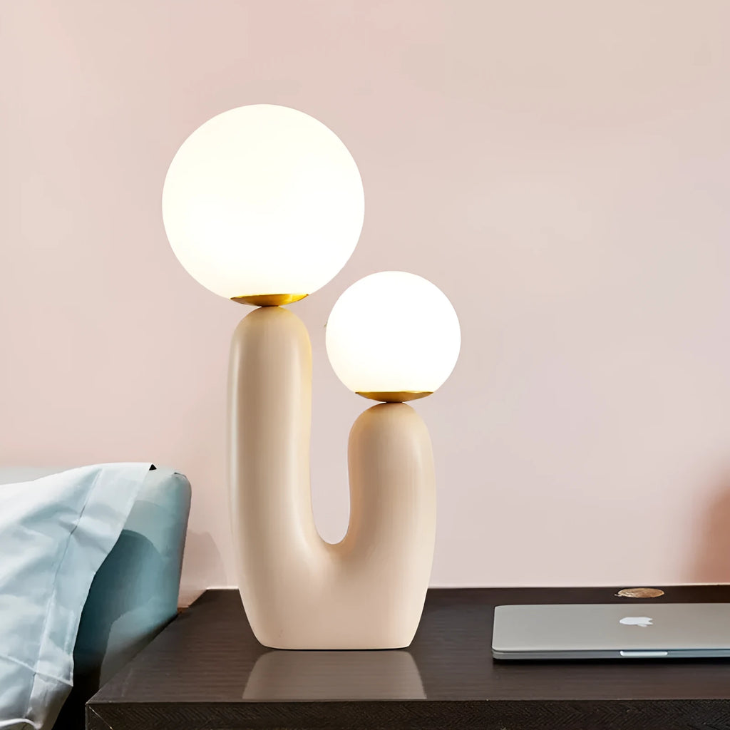 Pink double-head resin table lamp with glass shade on a bedside table, 49cm tall