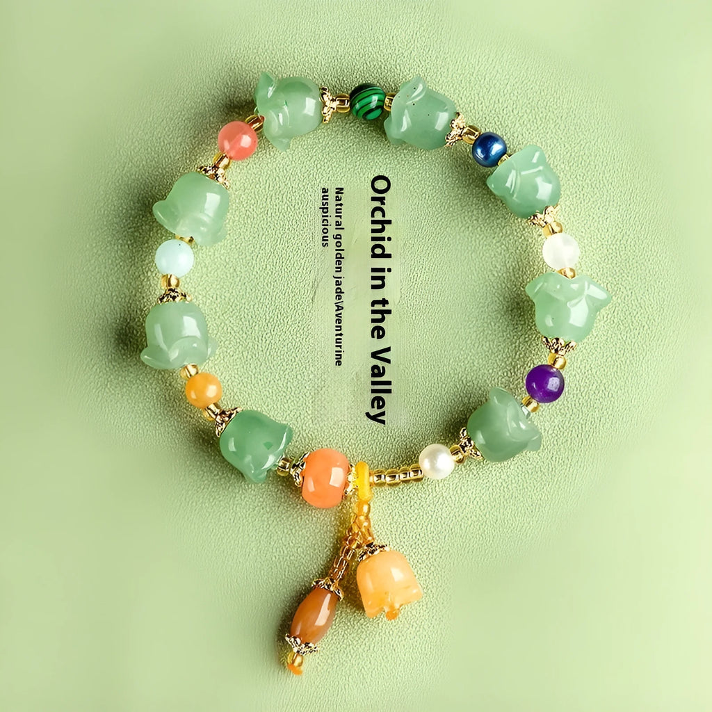 Natural Jinsi Jade bracelet with carved orchid beads on a wrist.