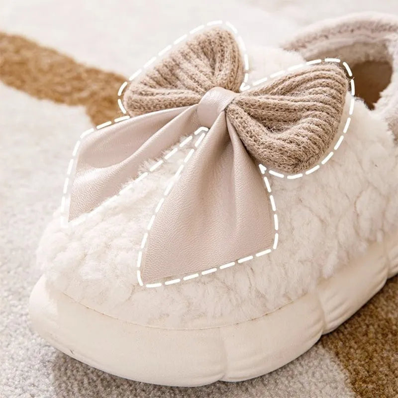 Big bow-knot fluffy slippers with covered heel in pink colour on floor