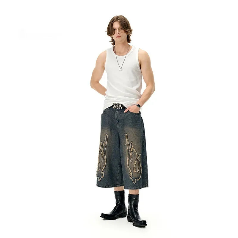 Men's black denim shorts with flame embroidery patch, cropped straight leg style