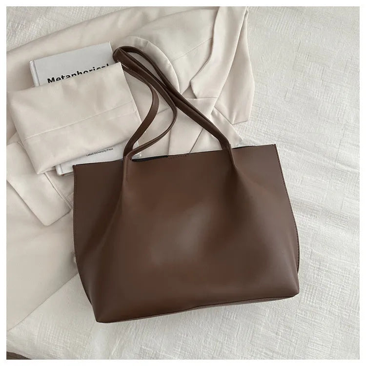 Casual messenger bag in PU leather with stitched detail, bucket shape, double shoulder straps, available in black brown coffee white