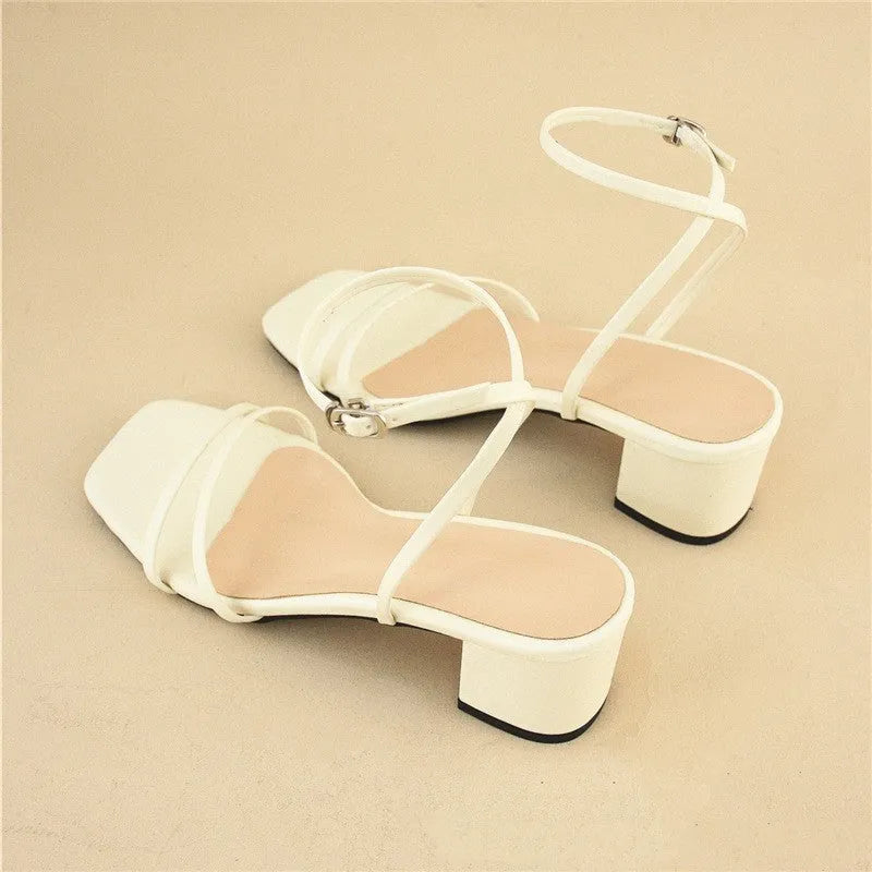 Beige women's chunky heel sandals with a square toe and ankle strap on a rubber sole.