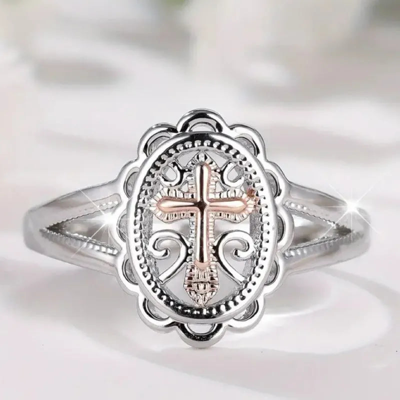 Silver electroplated alloy ring with detailed cross and lace design for women.