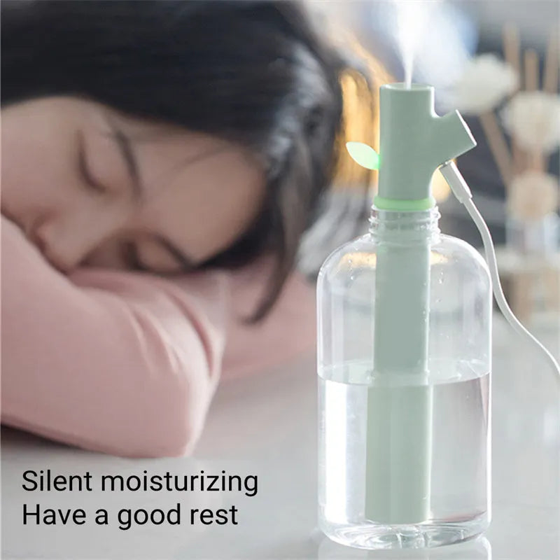 Transparent round portable USB ultrasonic cool mist humidifier on a desk